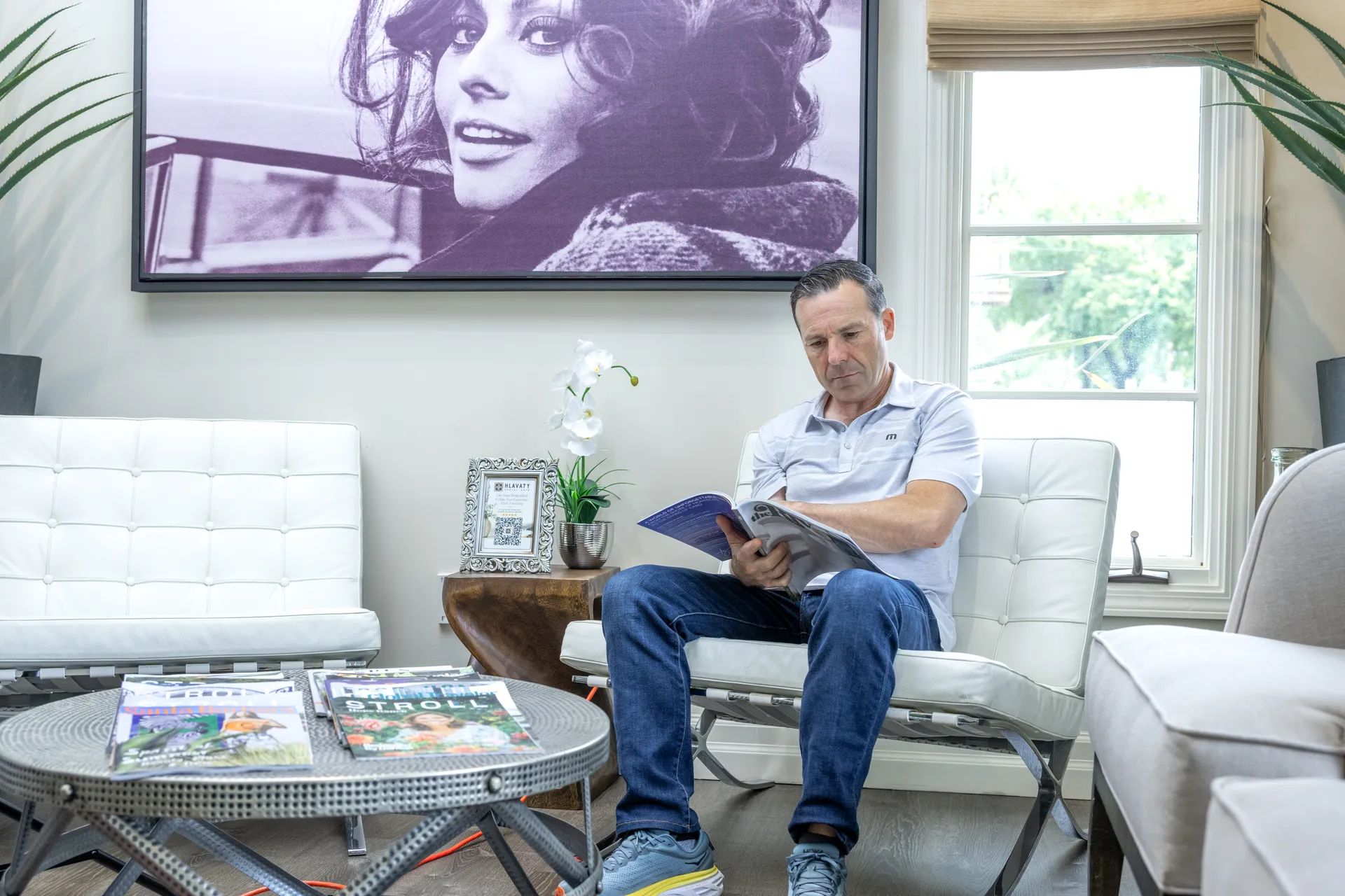 Patient relaxing with a magazine in the boutique waiting lounge